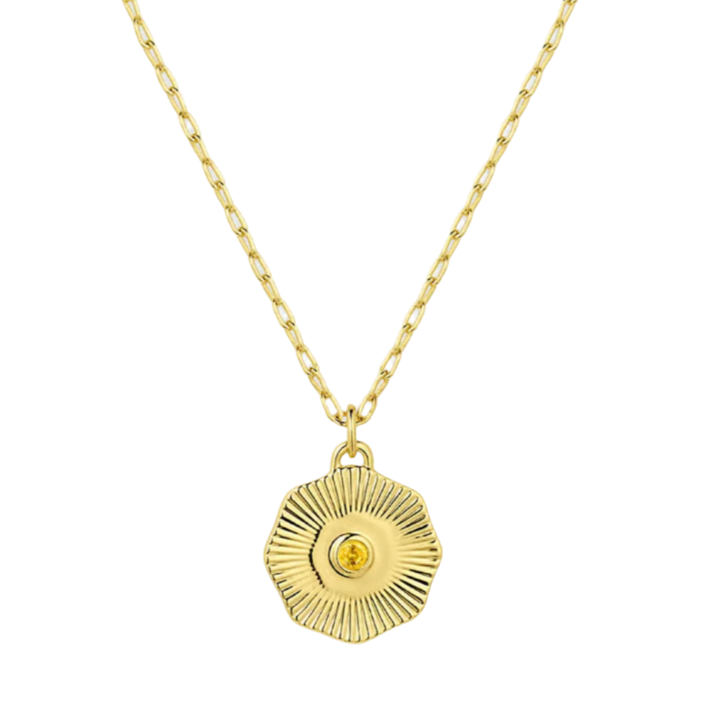 Gold necklace with a round pendant on a white background