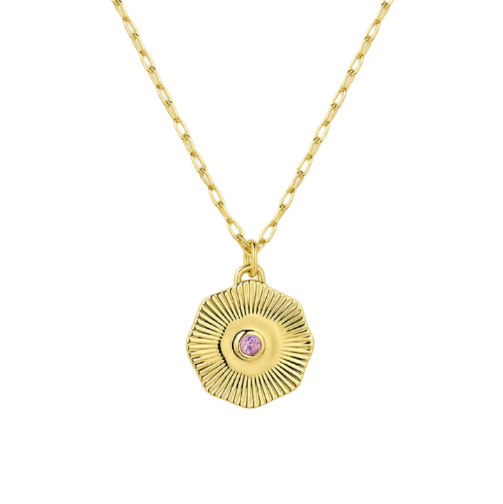 Gold necklace with a circular pendant featuring a pink gemstone on a white background