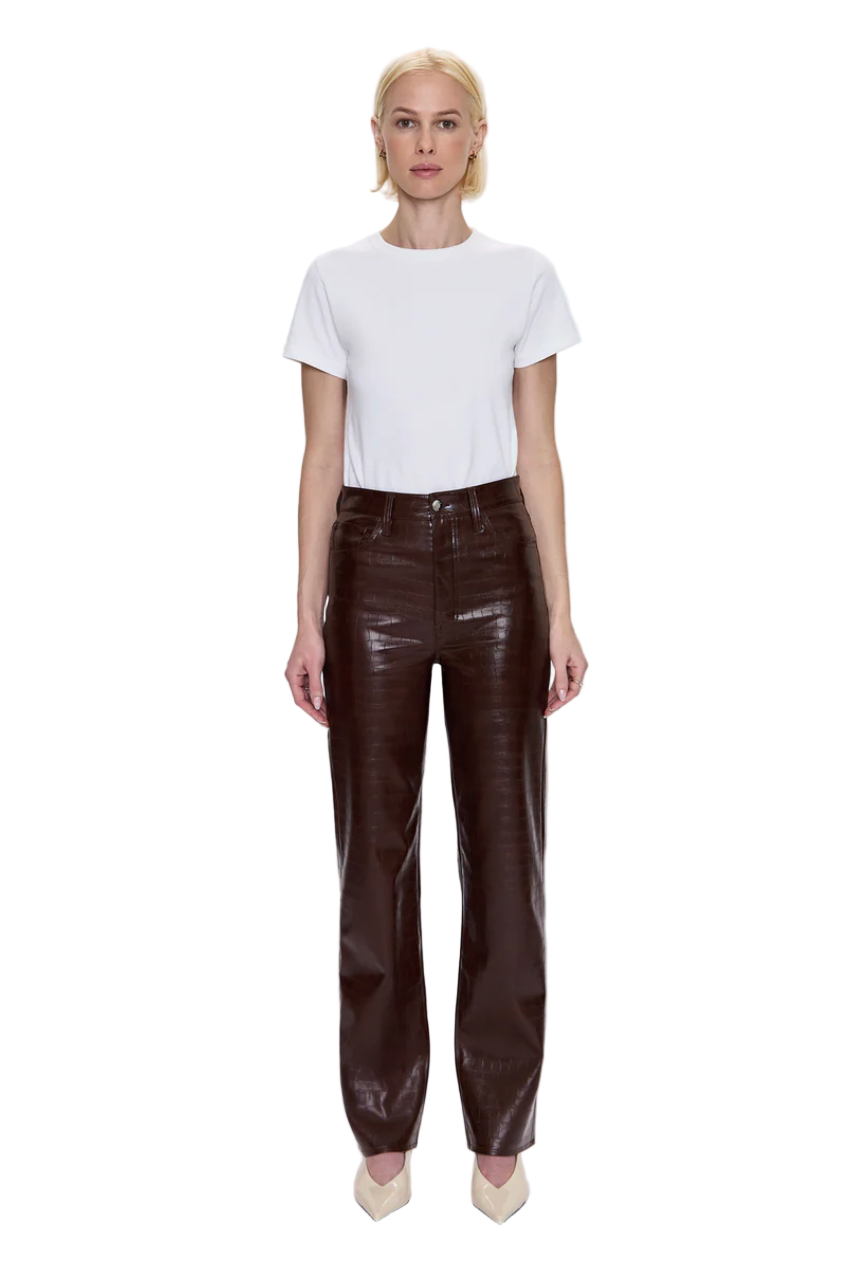 Person wearing a white t-shirt and brown leather pants on a white background