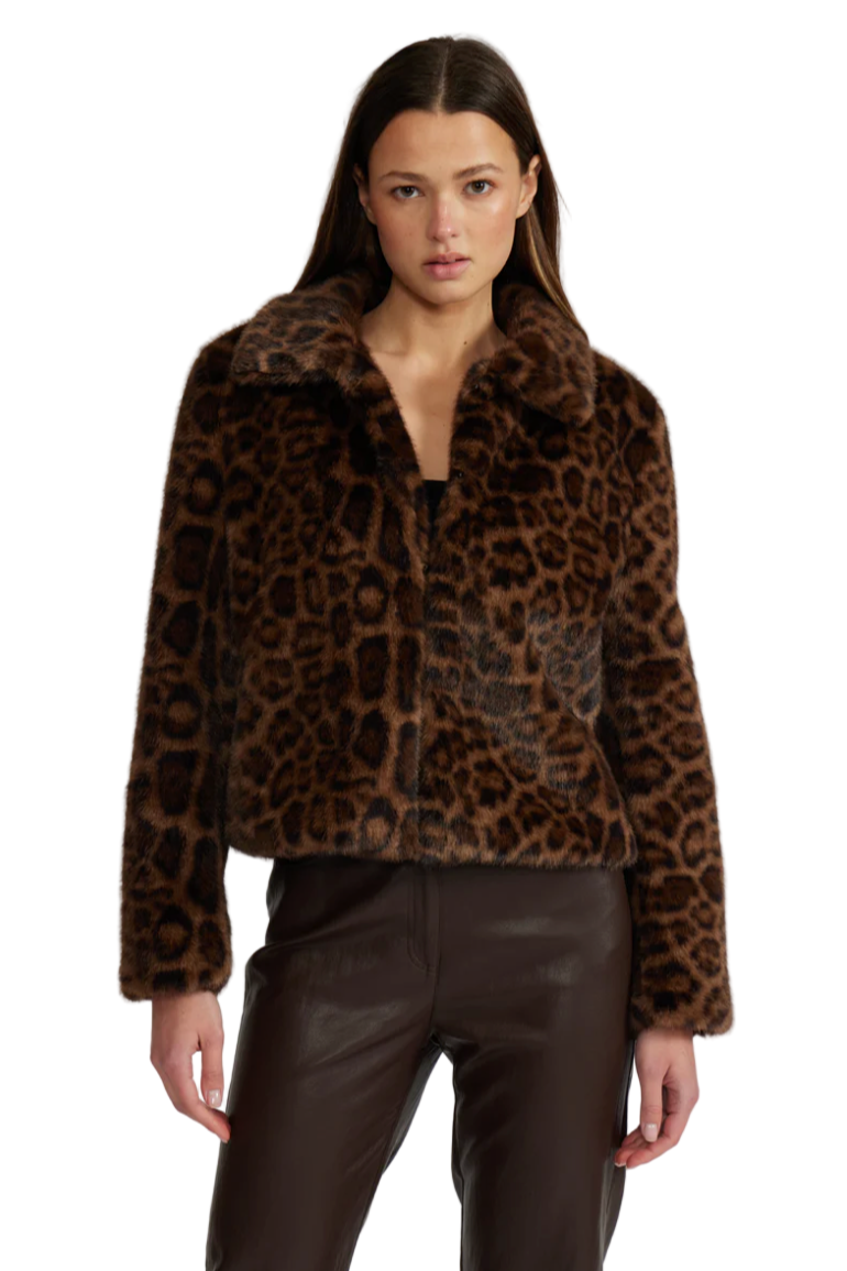 Woman wearing a leopard print jacket on a white background