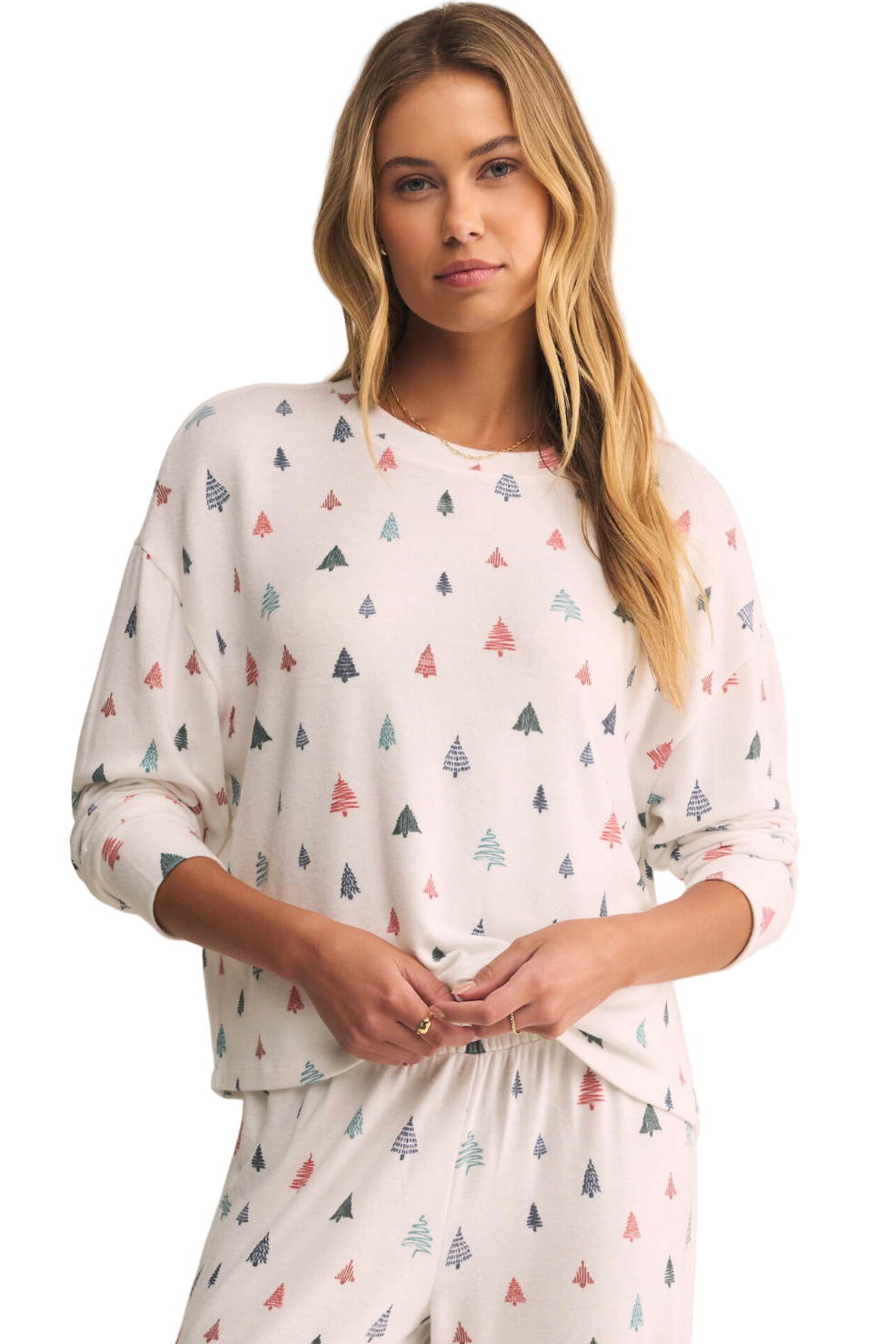 Woman wearing a white pajama set with small tree patterns on a beige background