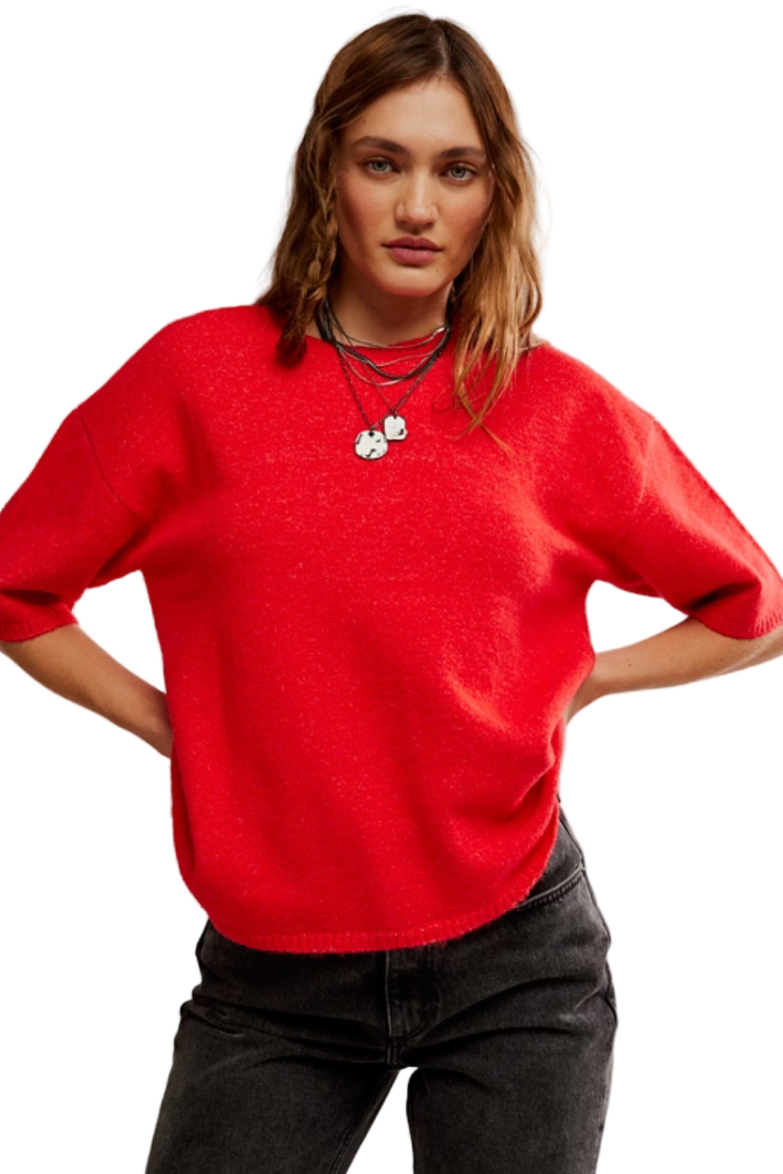Person wearing a red sweater and black pants on a plain background