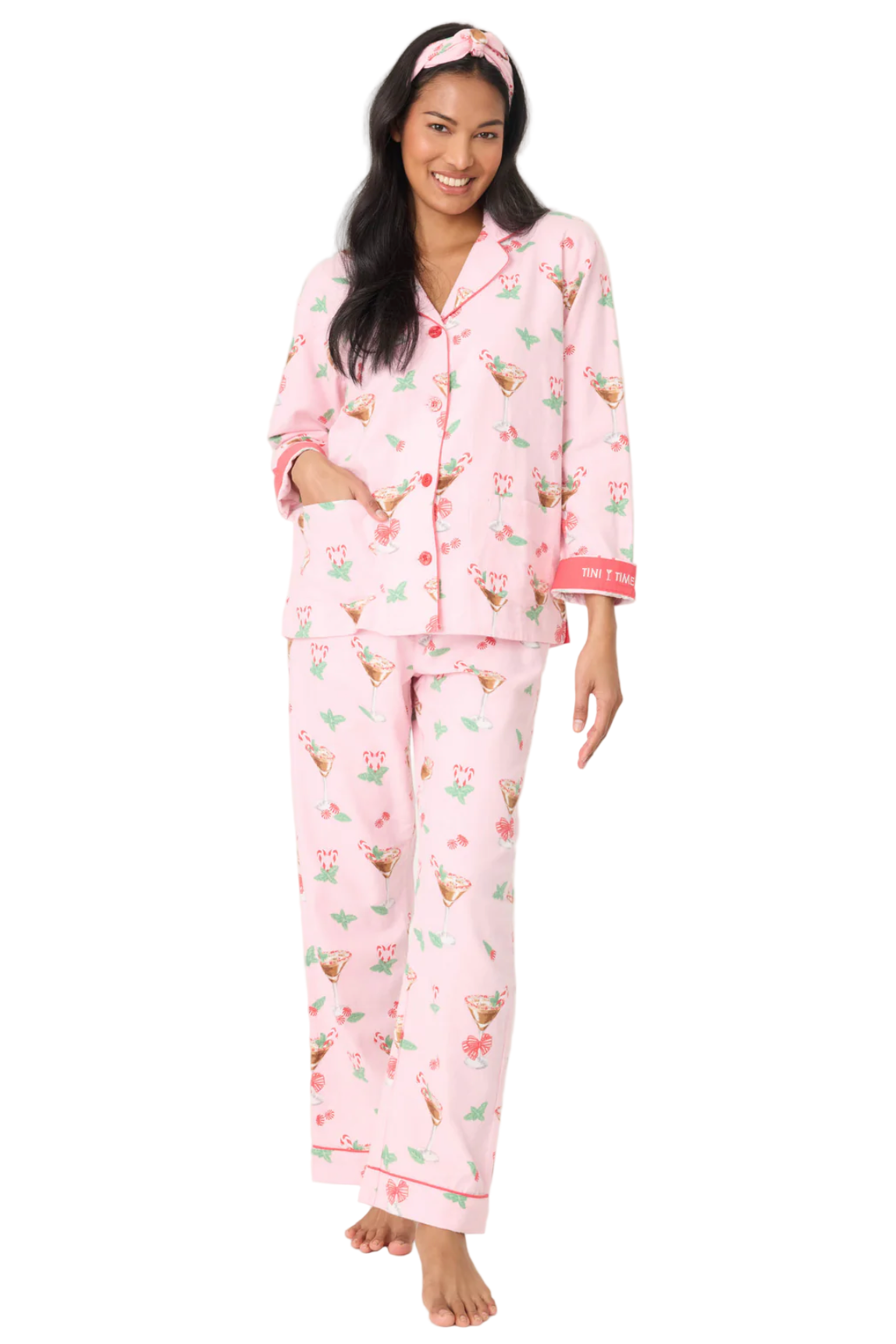 Woman wearing pink pajamas with a pattern on a white background