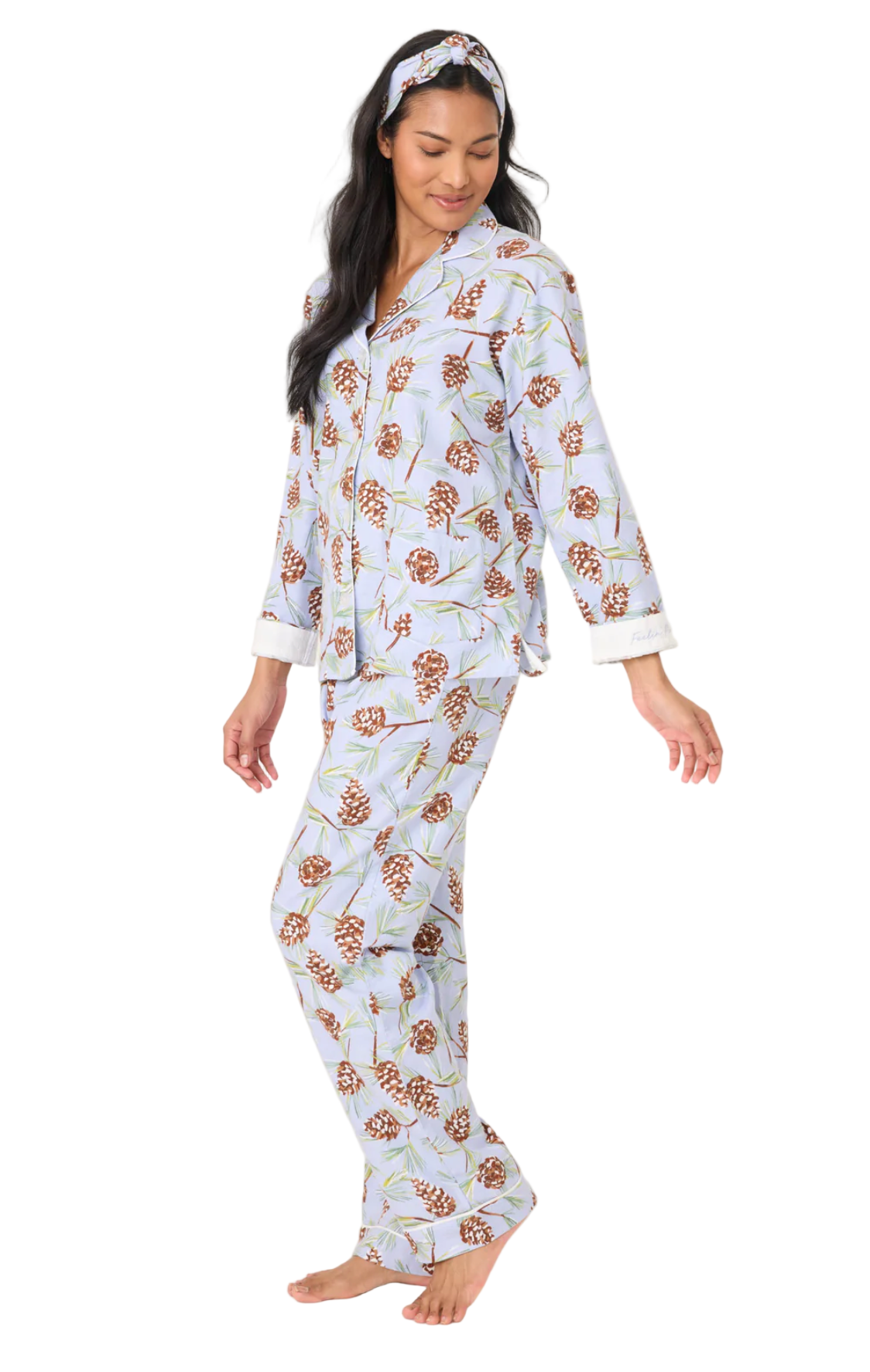 Woman wearing a floral pajama set on a white background