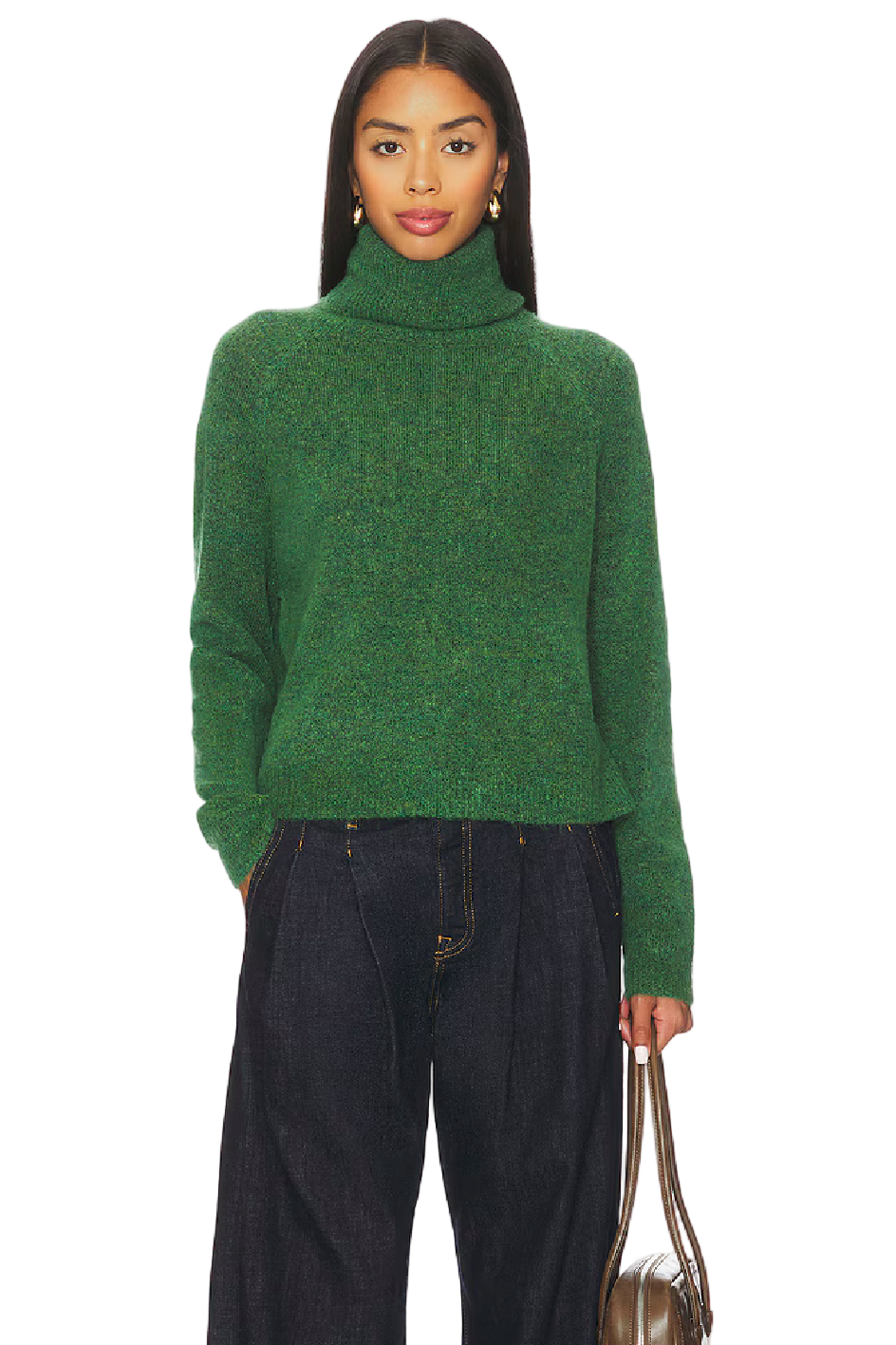 Person wearing a green sweater and black pants holding a brown handbag on a white background