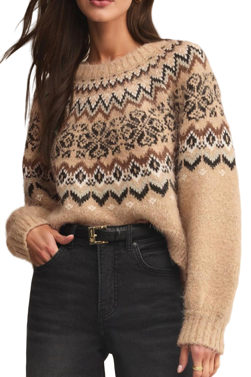 Person wearing a patterned sweater with black pants on a neutral background