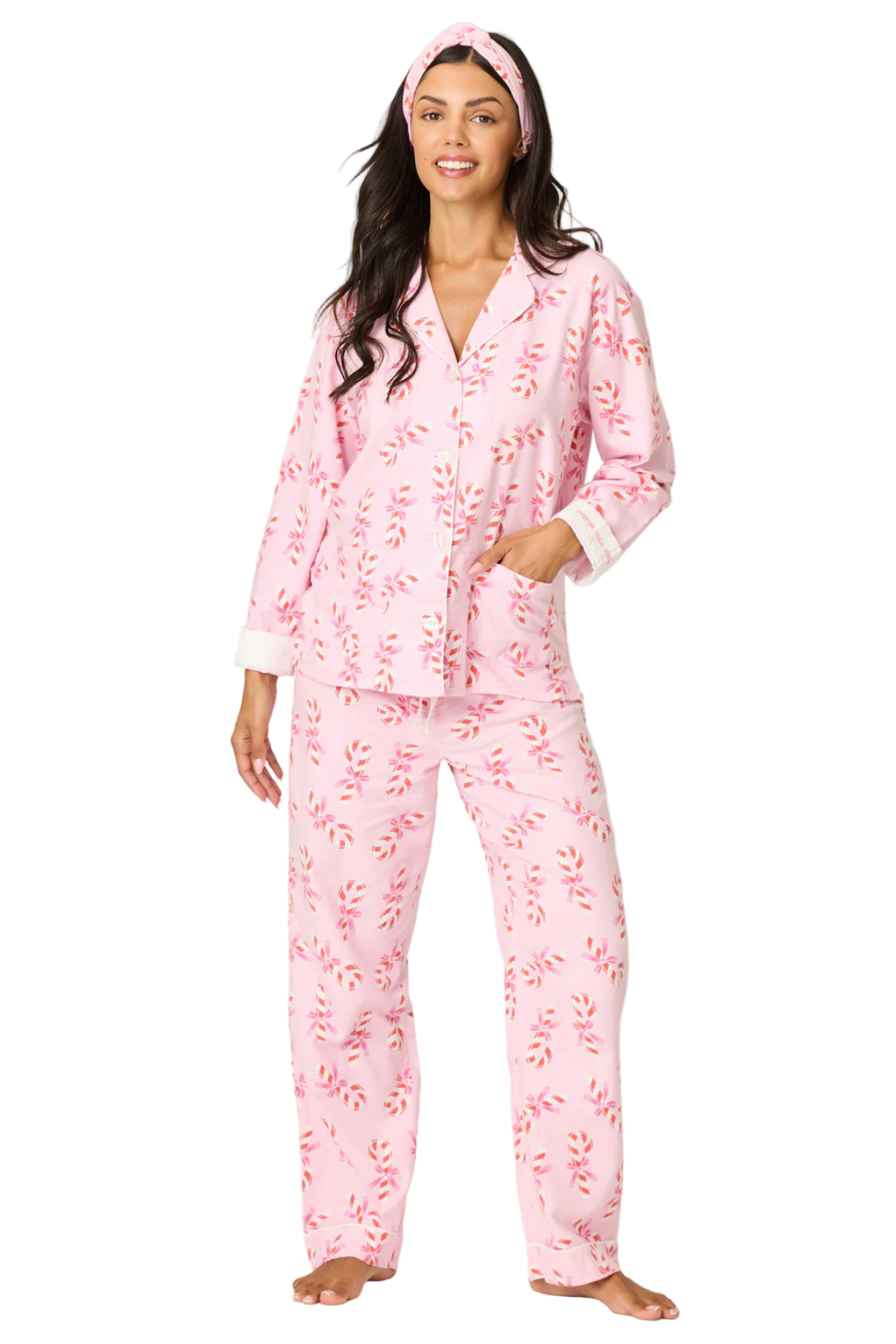 Woman wearing pink floral pajamas on a white background