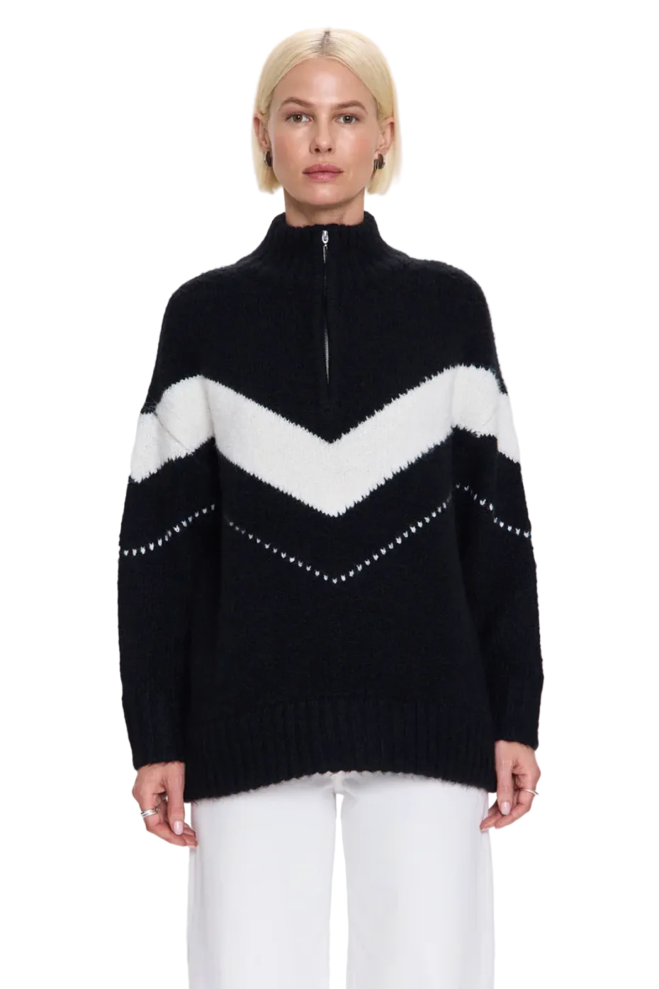 Person wearing a black and white striped sweater with a high collar on a light gray background