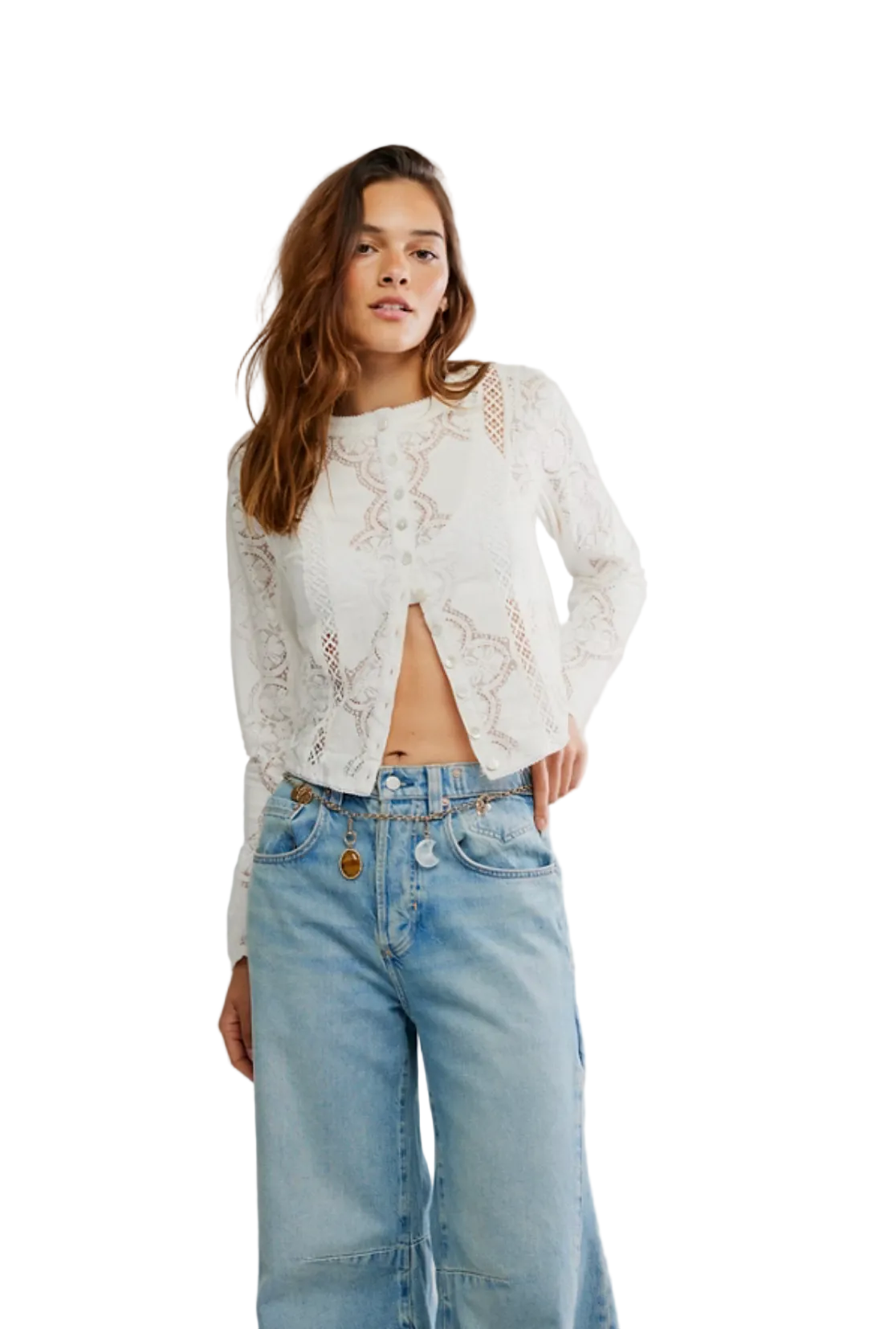 Woman wearing a white lace top and blue jeans on a plain background