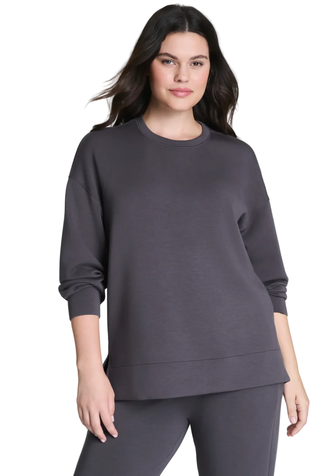 Woman wearing a gray sweatshirt and pants on a white background