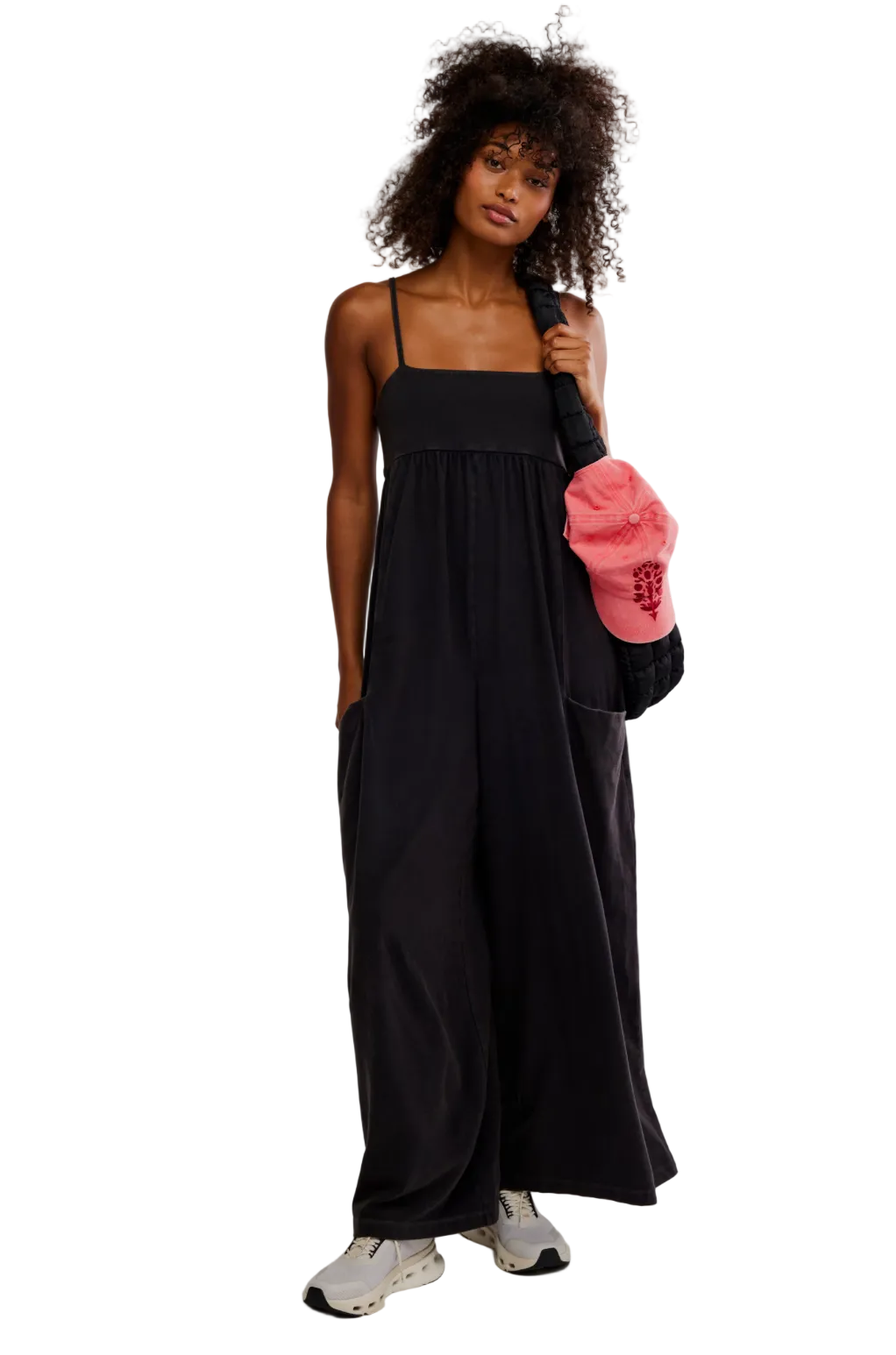 Woman wearing FP Movement Hot Shot Strappy Onesie 2 featuring a relaxed fit, lightweight fabric, and strappy back detail for sporty everyday style.