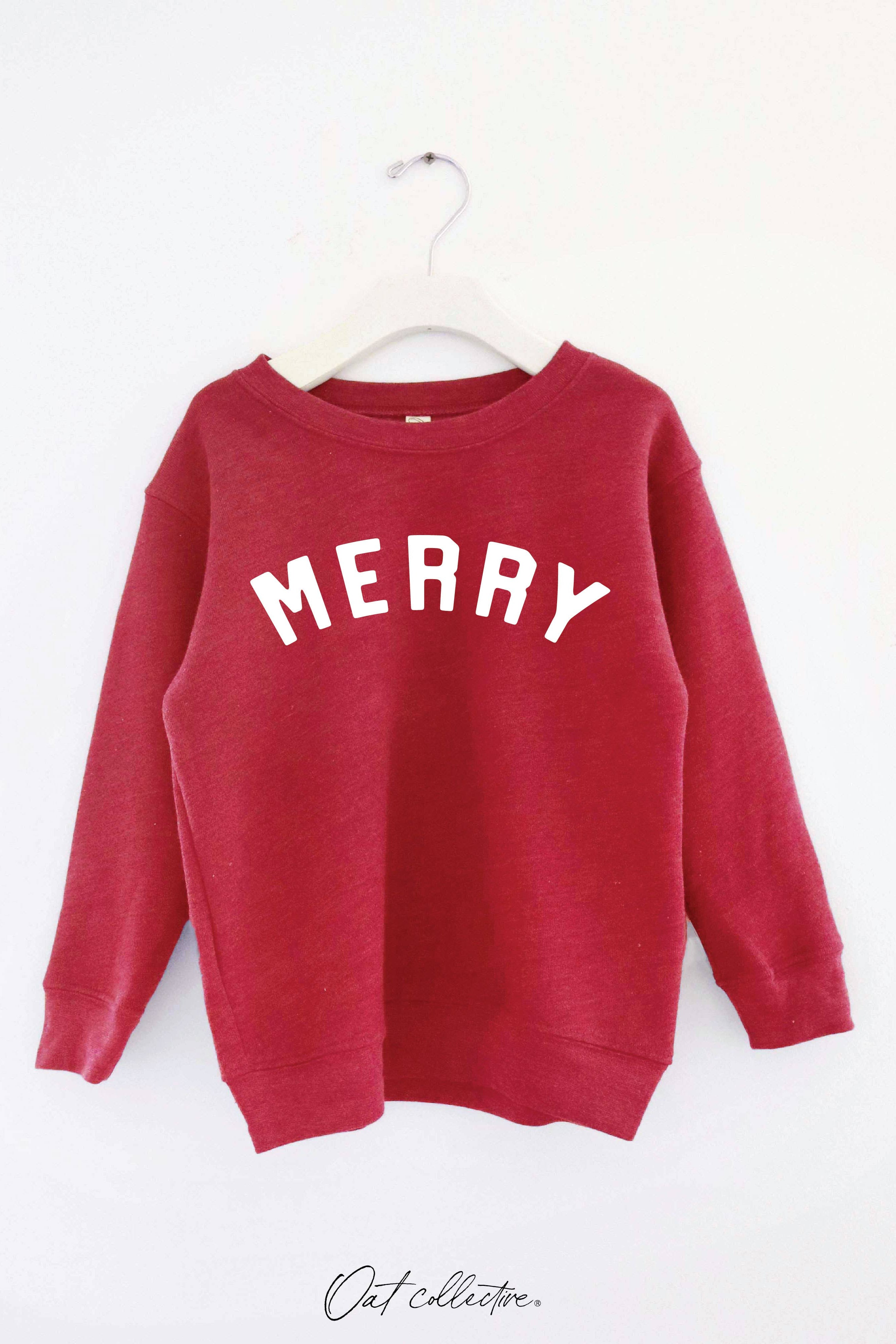 Oat Collective Toddler Red sweatshirt with 'MERRY' text on a white background