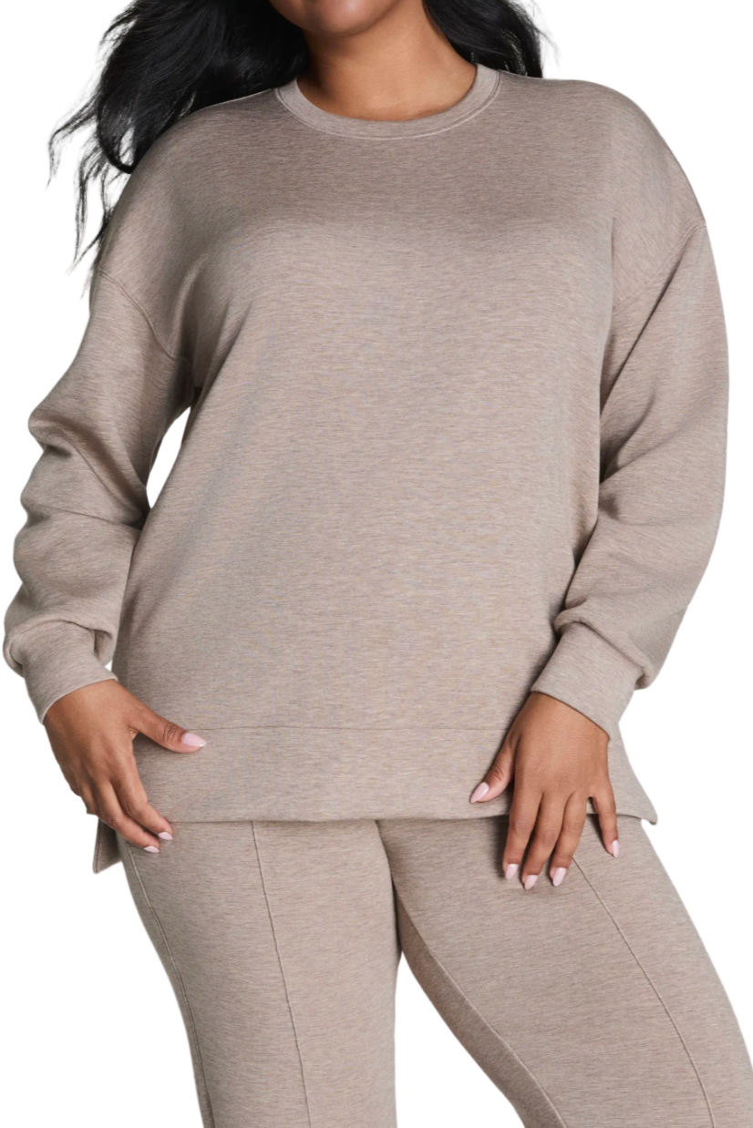 Beige sweatshirt and pants set on a white background