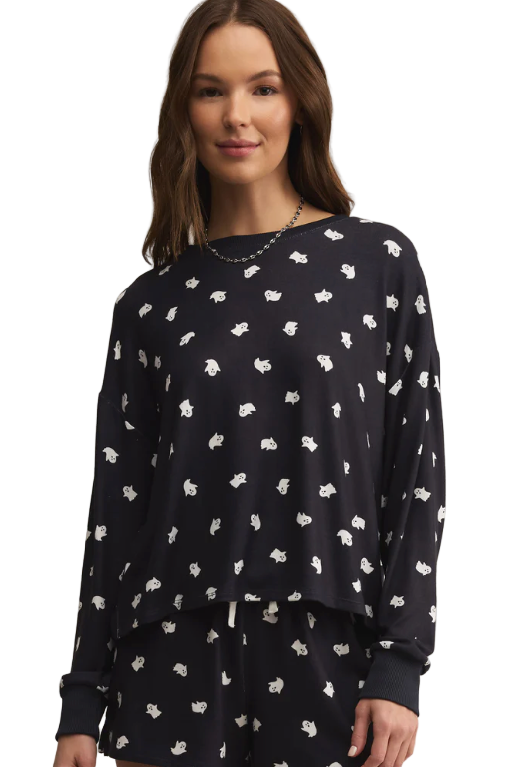 Woman wearing a black sweater with white pattern on a white background
