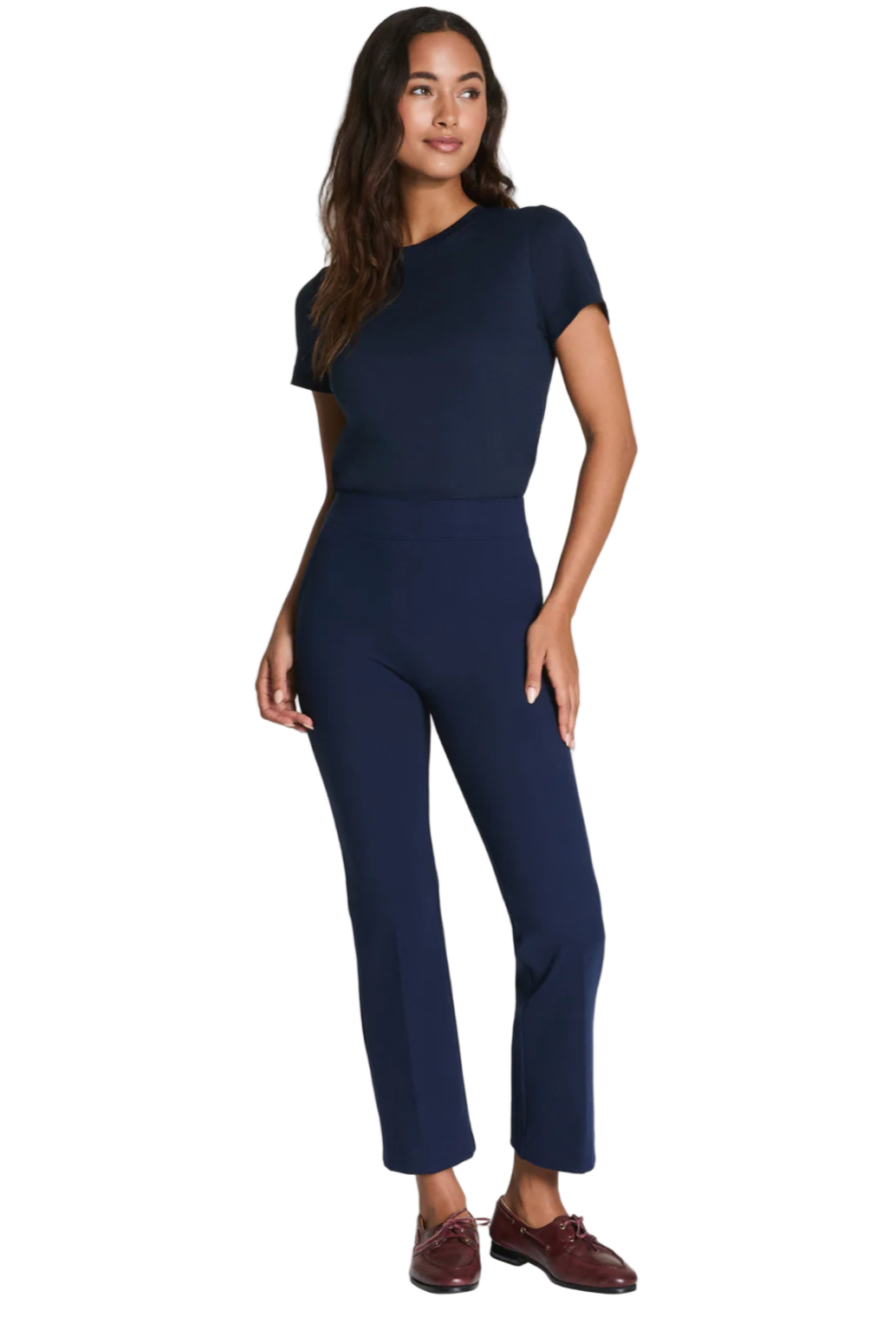 Woman wearing a navy blue outfit on a white background