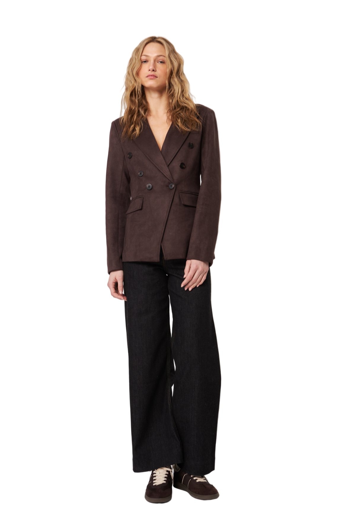 Woman wearing a brown blazer and black pants on a white background
