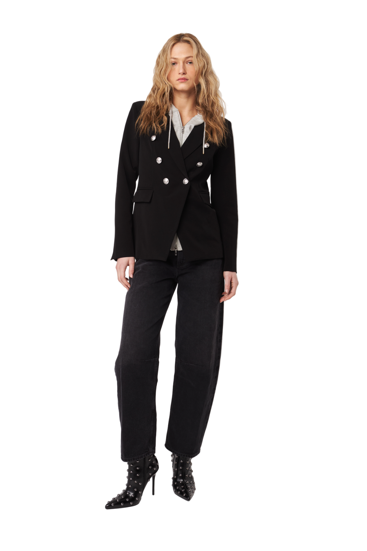 Woman wearing a black suit with white buttons on a white background