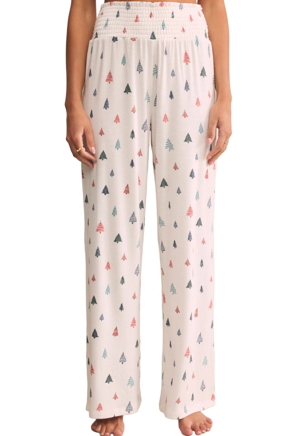 White pants with colorful geometric pattern worn by a person on a beige background