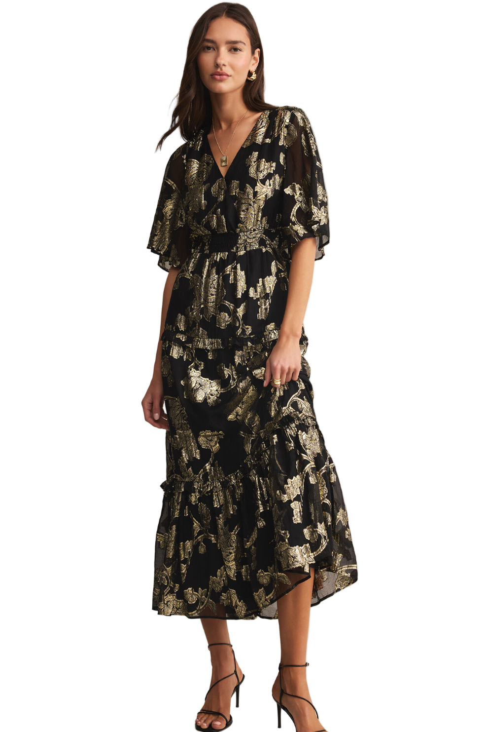 Woman wearing a black floral dress on a beige background