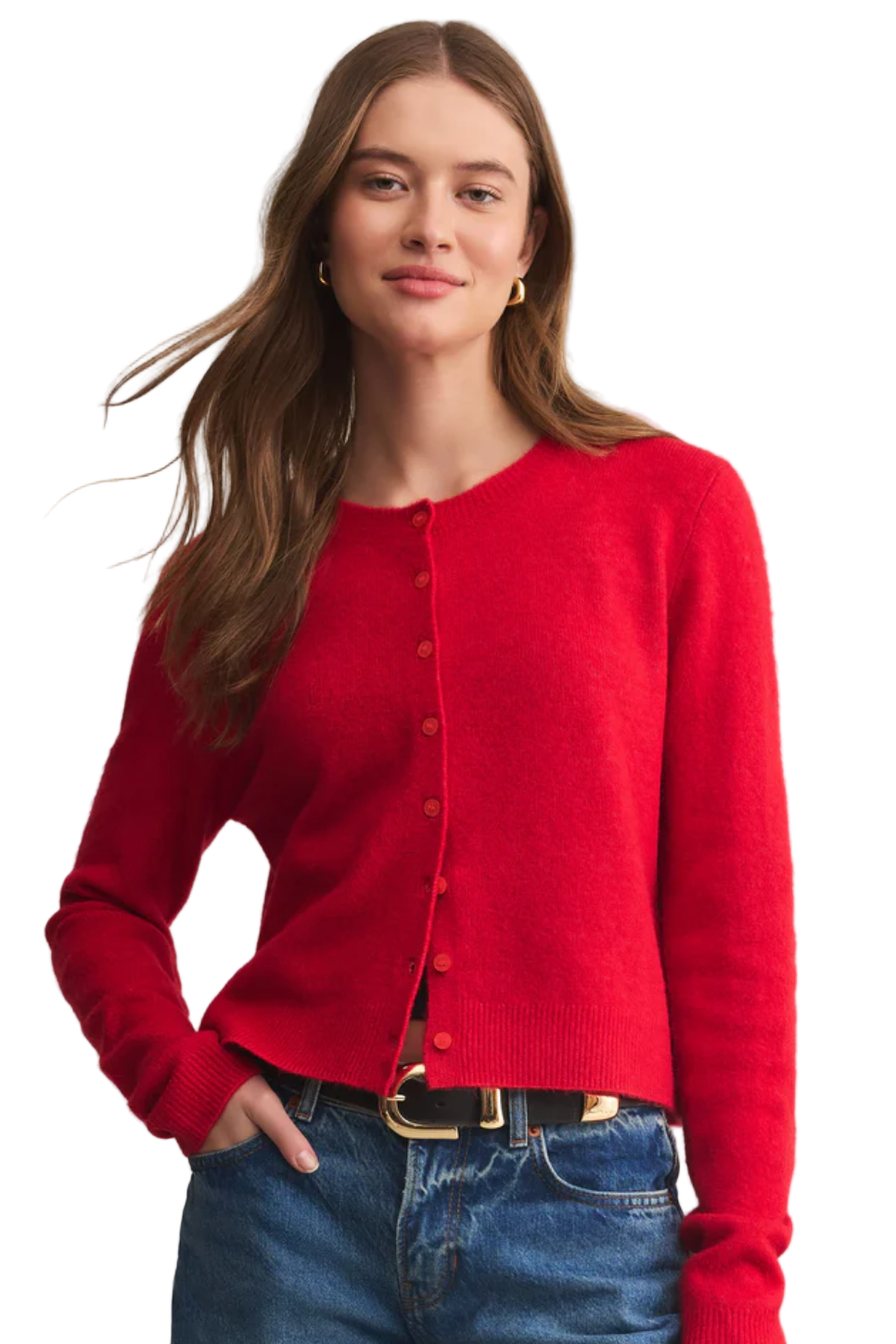Woman wearing a red cardigan and blue jeans on a beige background
