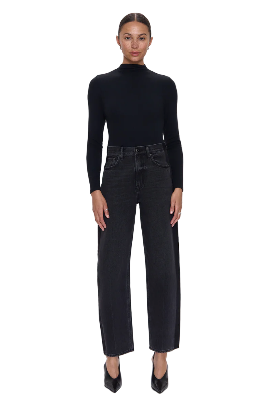 Person wearing a black turtleneck and black jeans on a white background