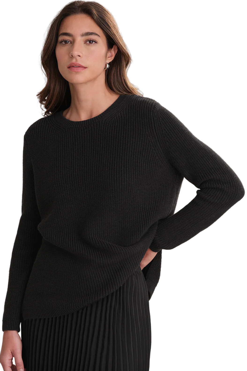Woman wearing a black sweater against a neutral background