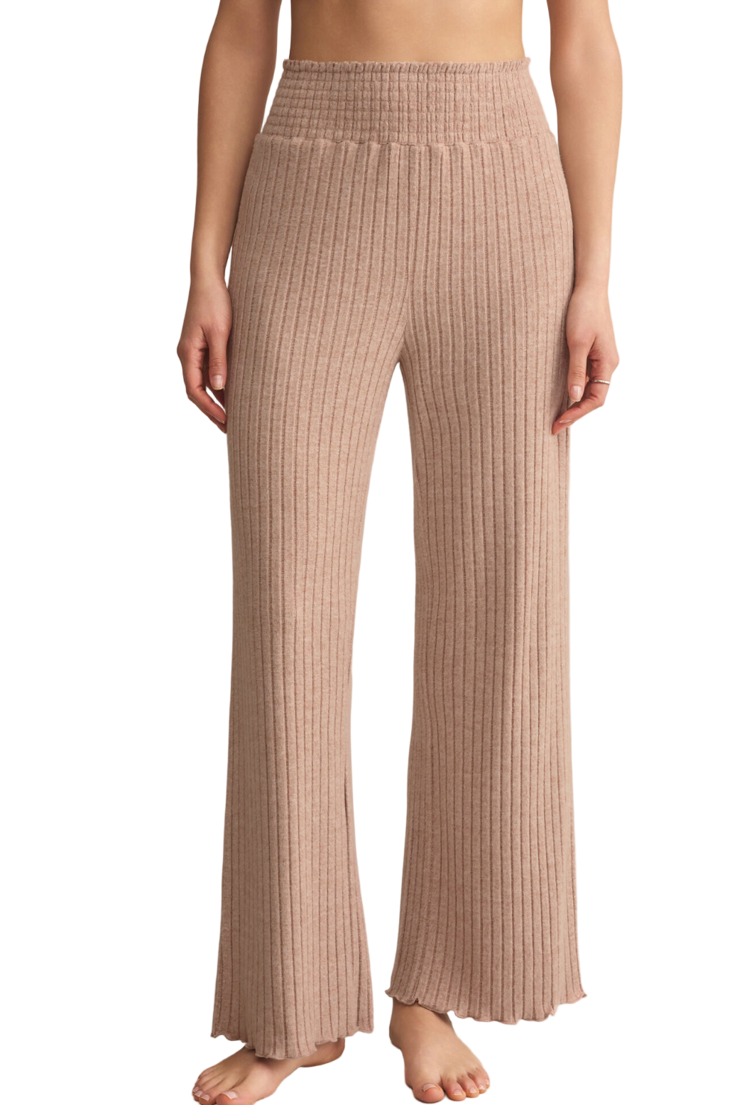 Person wearing ribbed knit pants on a plain background
