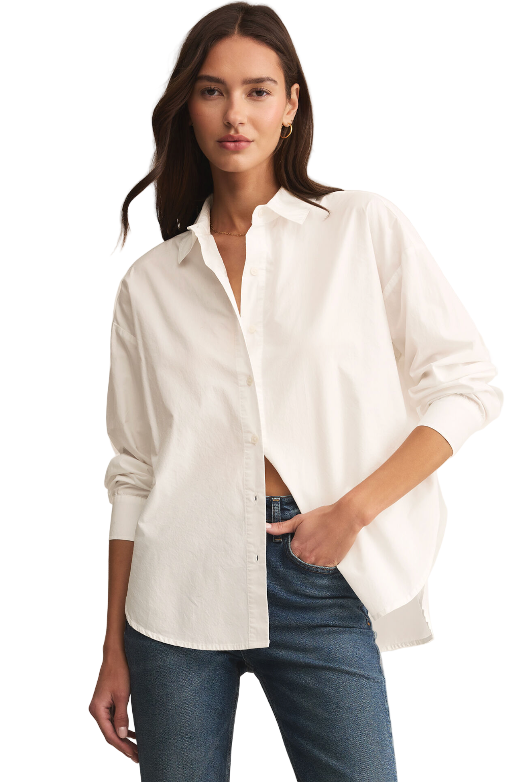Woman wearing a white button-up shirt and blue jeans on a beige background