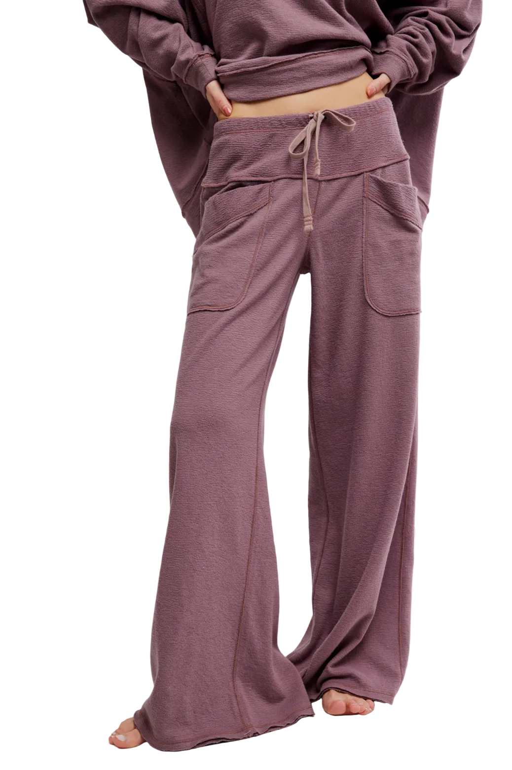 High-rise lounge sweatpants with straight leg, drawstring waistband, oversized side pockets, and raw hem for relaxed everyday style