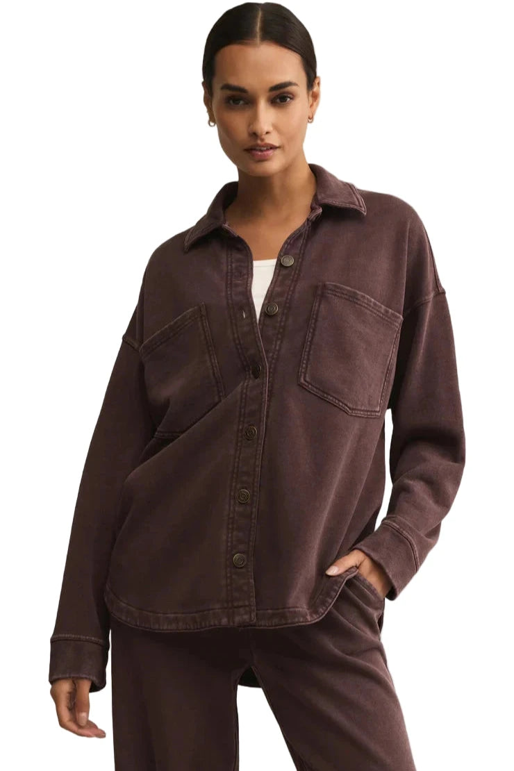 Woman wearing a brown shirt and pants on a white background