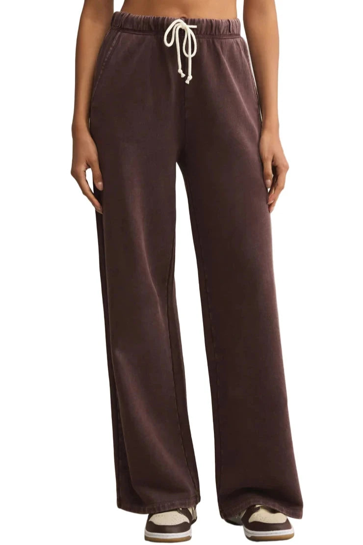 Brown sweatpants with a drawstring on a beige background